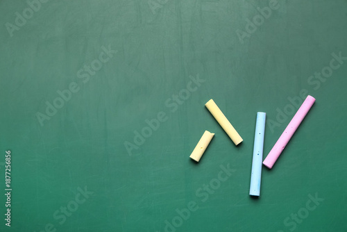 Colorful chalks on green bl...