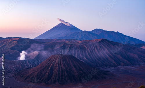 Mount Bromo, in the Tengger Caldera, with Semeru volcano behind. Glowing orange mist recedes from the Tengger Sand Sea, Indonesia's only desert landscape; Pananjakan, Java