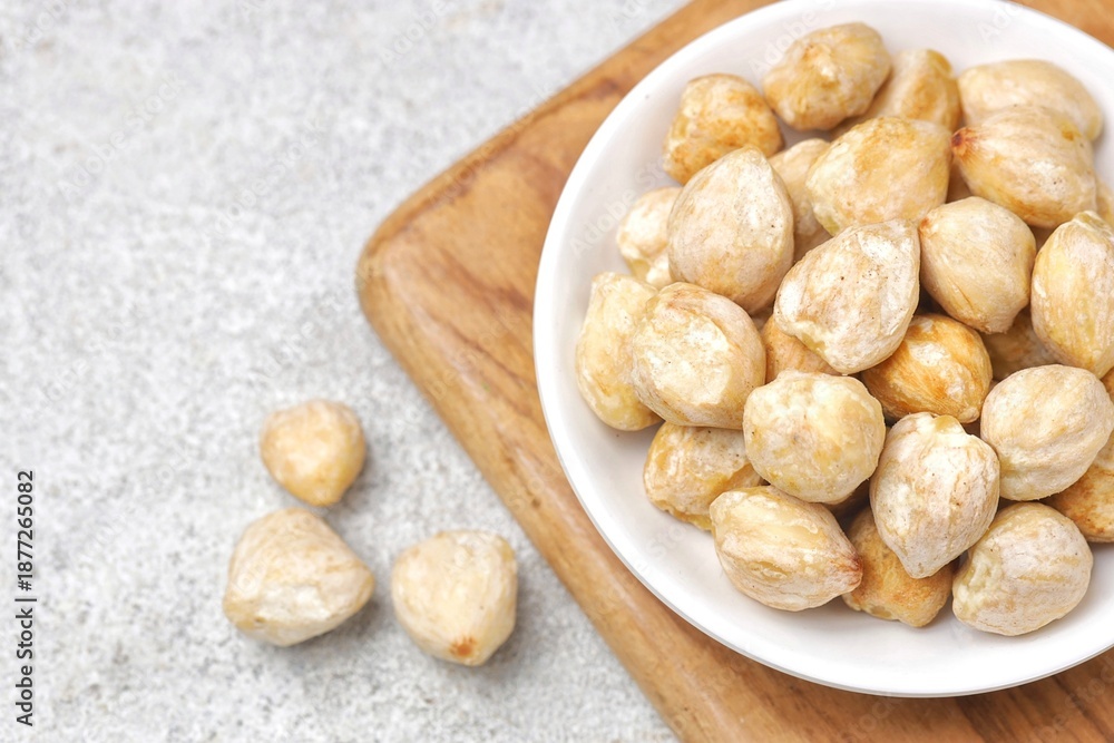 Fototapeta premium candlenut also known as kemiri, one of herbs that usually used for asian food as seasoning