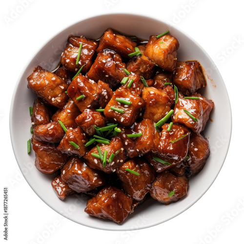 Glazed meat cubes with sesame seeds and chives in bowl isolated on white background