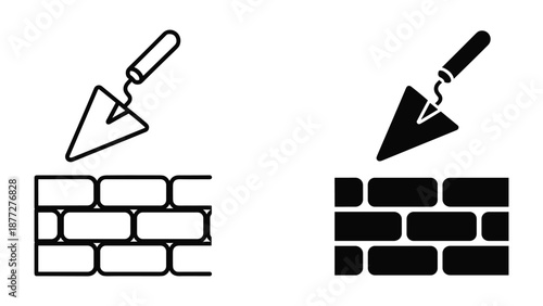 Trowel applying mortar to brick wall