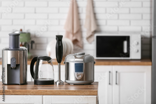 Different modern household appliances on counter in kitchen © Pixel-Shot