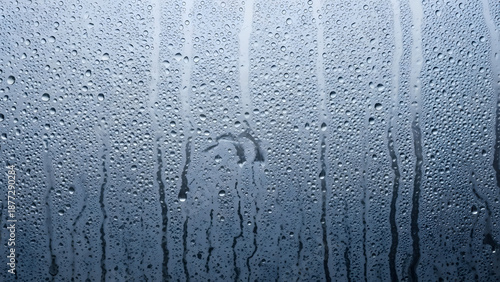 Heavy condensation water drops on a steamy window glass