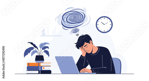 Exhausted young man feeling overwhelmed and stressed while working late on laptop at desk surrounded by piles of academic books.