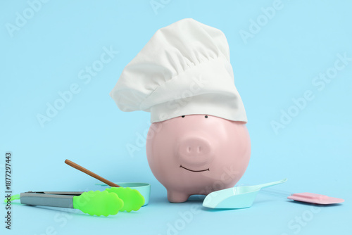 Piggy bank in chef's hat wi...