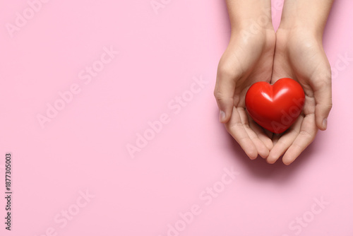 Female hands holding red he...