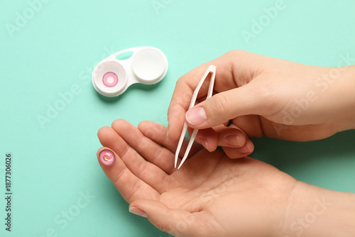Female hands with tweezers ...