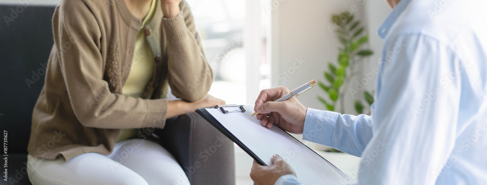 Naklejka premium mental health treatment concept. Stressed asian patient talking with personal psychologist in therapist session have a burnout in work at clinic in office room.
