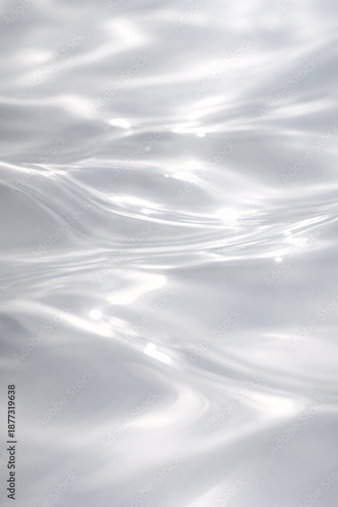 Obraz premium Close-up of shimmering white water surface with gentle ripples and light reflections.