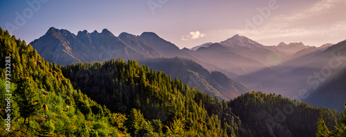 Panorama of the mountains. Majestic Golden Hour Over Sainj Valley, Himachal Pradesh. This serene landscape showcases the majestic Himalayan peaks and traditional mountain scenery of Northern India.