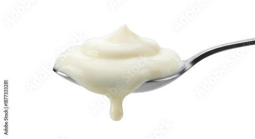A spoonful of creamy white sauce or yogurt dripping back into the air