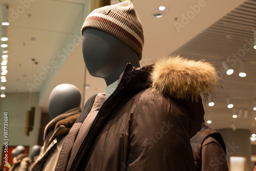 Canvas-taulu Warm brown jacket with fur trimmed hood on mannequin wearing hat
