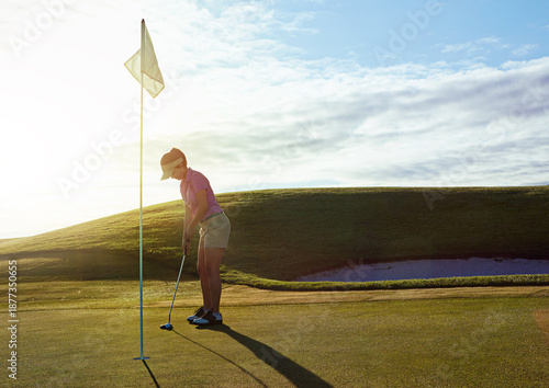 Woman, play and aim with flagstick on golf course for game, practice session and green fairway. Space, female person and shot for target of match, golfer technique and recreational sports outdoor
