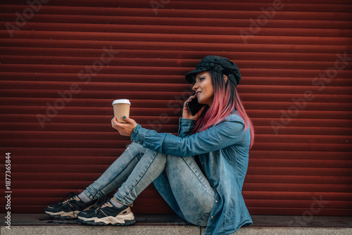 Wallpaper Mural girl talking on the mobile phone outdoors with a blind on a red background Torontodigital.ca