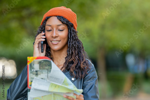 Wallpaper Mural young woman traveling talking on phone outdoors looking at map Torontodigital.ca