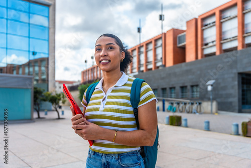 Fotografie Young latina student walking across university campus
