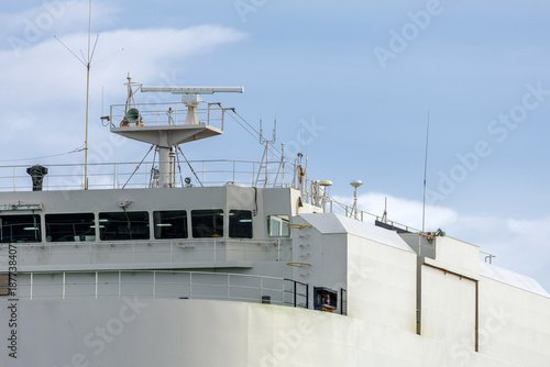 Bild auf Leinwand Horizontal view berthed Ro-Ro cargo ship's upper deck showing bridge windows, radar, antennas and various communication equipment