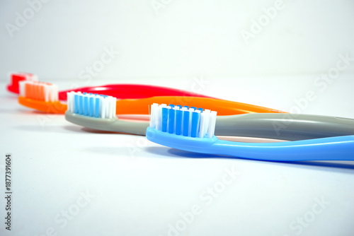 Vibrant toothbrushes pairing together on a sleek white background, evoking a sense of cleanliness and oral health, Daily routine concept photography
