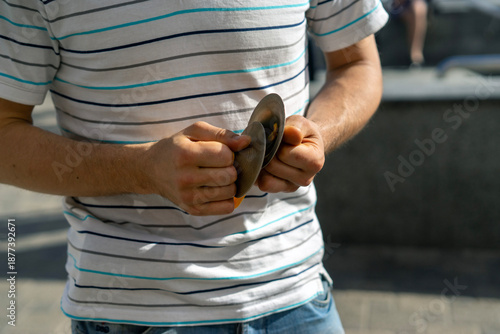 Playing Finger Cymbals (Zills) Outdoors – Close-Up of Hands