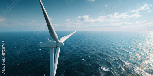 A wind turbine generating clean energy over the vast ocean under clear sky