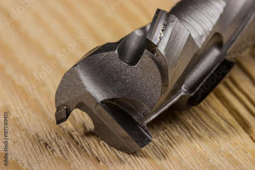 Photography diamond woodworking cutter on a wooden background in close-up