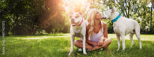 Fotografija Woman, love and kiss with dogs in nature for pet care or bonding together in outdoor park