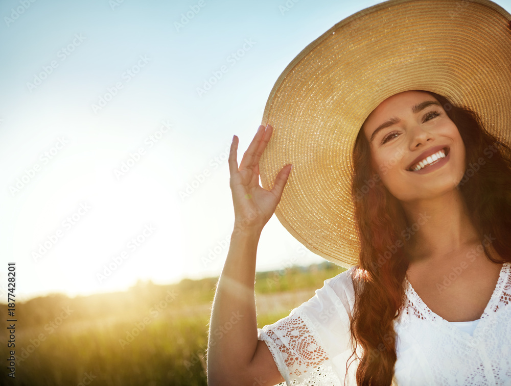 Fototapeta premium Portrait, woman and smile for travel outdoor with peace, fresh air and calm morning on holiday. Space, female person and vacation with straw hat in field, weekend break and summer trip in countryside