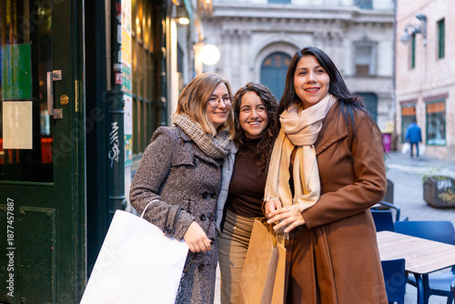Women friends enjoying winter city shopping together