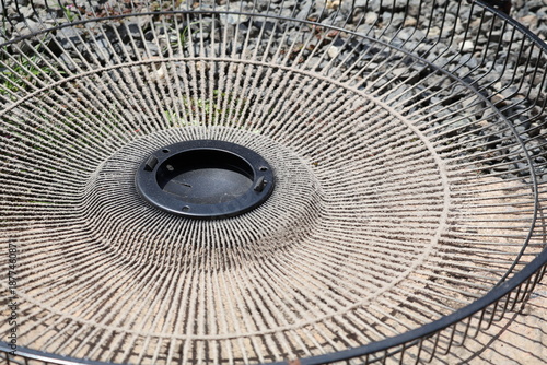 The dusty cover of an electric fan. dirty electric fan, unclean, unhygienic, air pollution in home, concept of health care and hygiene, dust mite allergy, allergic. 