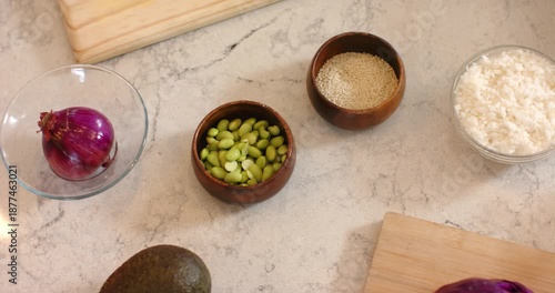 Upon start, vegetables and grains are being introduced and arranged on cutting board for meal prep