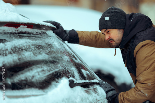 фотографія Man Pushes Car Stuck in Snow That Would Not Start