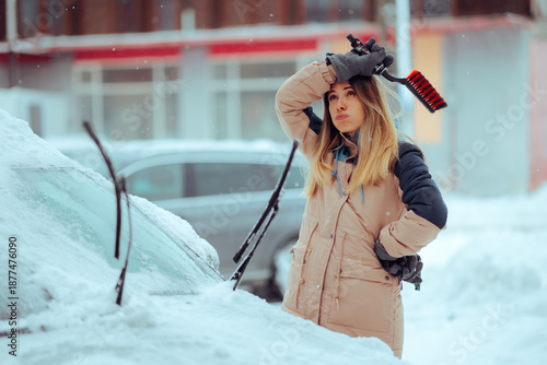 Tableau sur toile Tired Driver Holding a Snow Brush During Snowfall