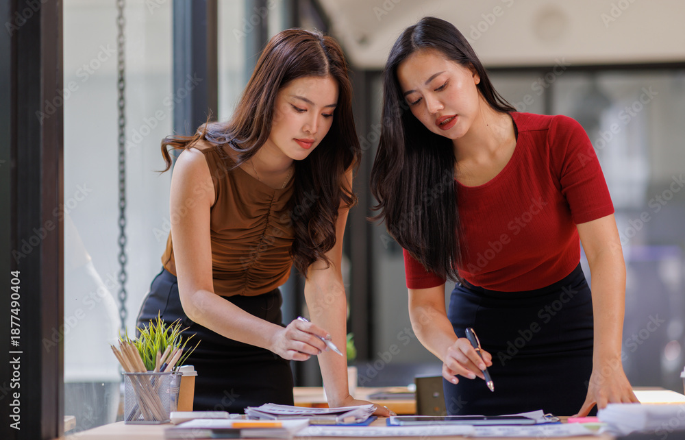 Fototapeta premium Discuss business women analytical price charts using calculators and laptops to calculate financial, tax, accounting, statistics and analytical research ideas. 