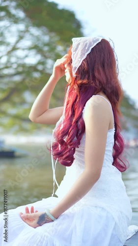 Young woman in a boat at sunset