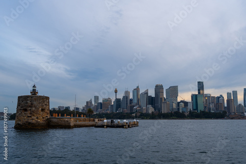 Sydney skyline at sunset with golden reflections on the water