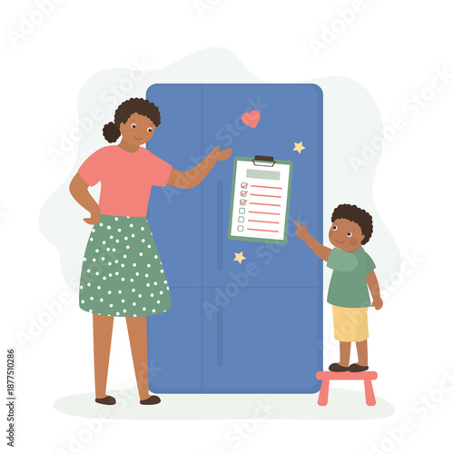 Happy mother and child talking, check finished daily tasks, to do list on refrigerator. Smiling mom and son put marks on to do list on fridge. Planning and time managemen