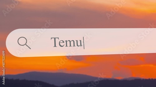 Typing in the search box for Temu while a sunset colors the sky. The view shows mountains and a lake as the search is done at evening time.