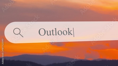 Typing the word Outlook in the search box while a sunset view appears in the background with mountains and water below.