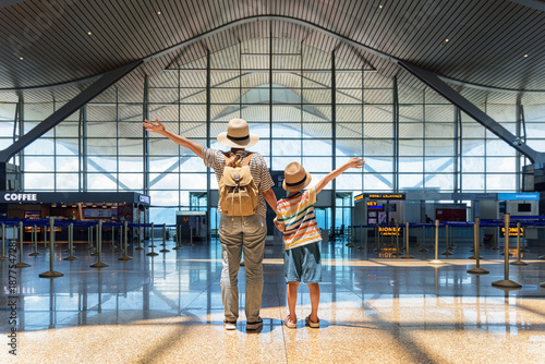 Wallpaper Mural Female tourist and her son with raised arms in airport Torontodigital.ca