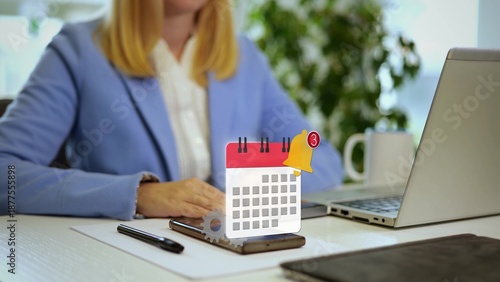 Quadro su tela Businesswoman in office receiving calendar notification alert on smartphone with