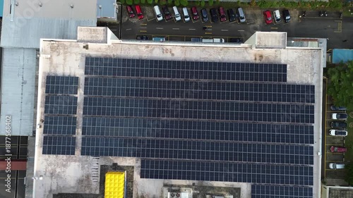 Harnessing solar power with large-scale photovoltaic systems adorn the roofs of commercial buildings and factories.