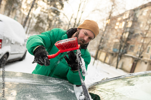Close-Up Man Removing Snow from Single Car Wiper Blade
