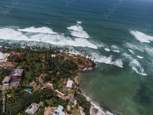 Aerial view of waves crashing on the shore in Sri Lanka, showing coastal erosion and rising sea levels