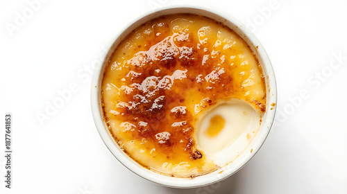 Top view of crème brûlée in white ramekin with caramelized sugar crust isolated on white