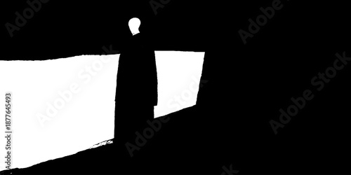 Silhouette of a male figure standing in a dark passageway with light contrast