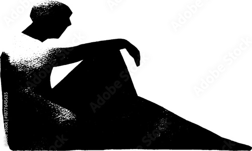Silhouette of seated male in thoughtful pose