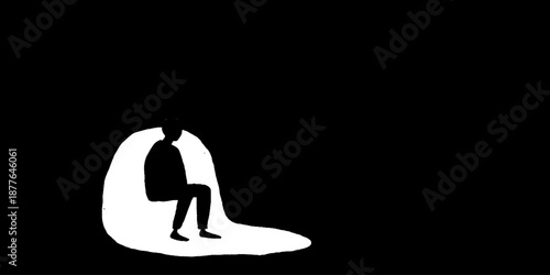 Silhouette of a seated person in shadow on black background