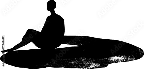 Silhouette of person sitting on rock
