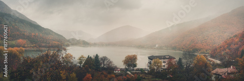 Moody Lakeside Landscape with Fall Foliage and Morning Fog