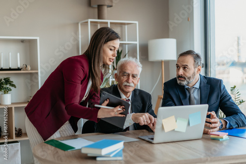 Multi-Generational Business Team Explaining Work to Senior Executive in Modern Office – Family Business Concept